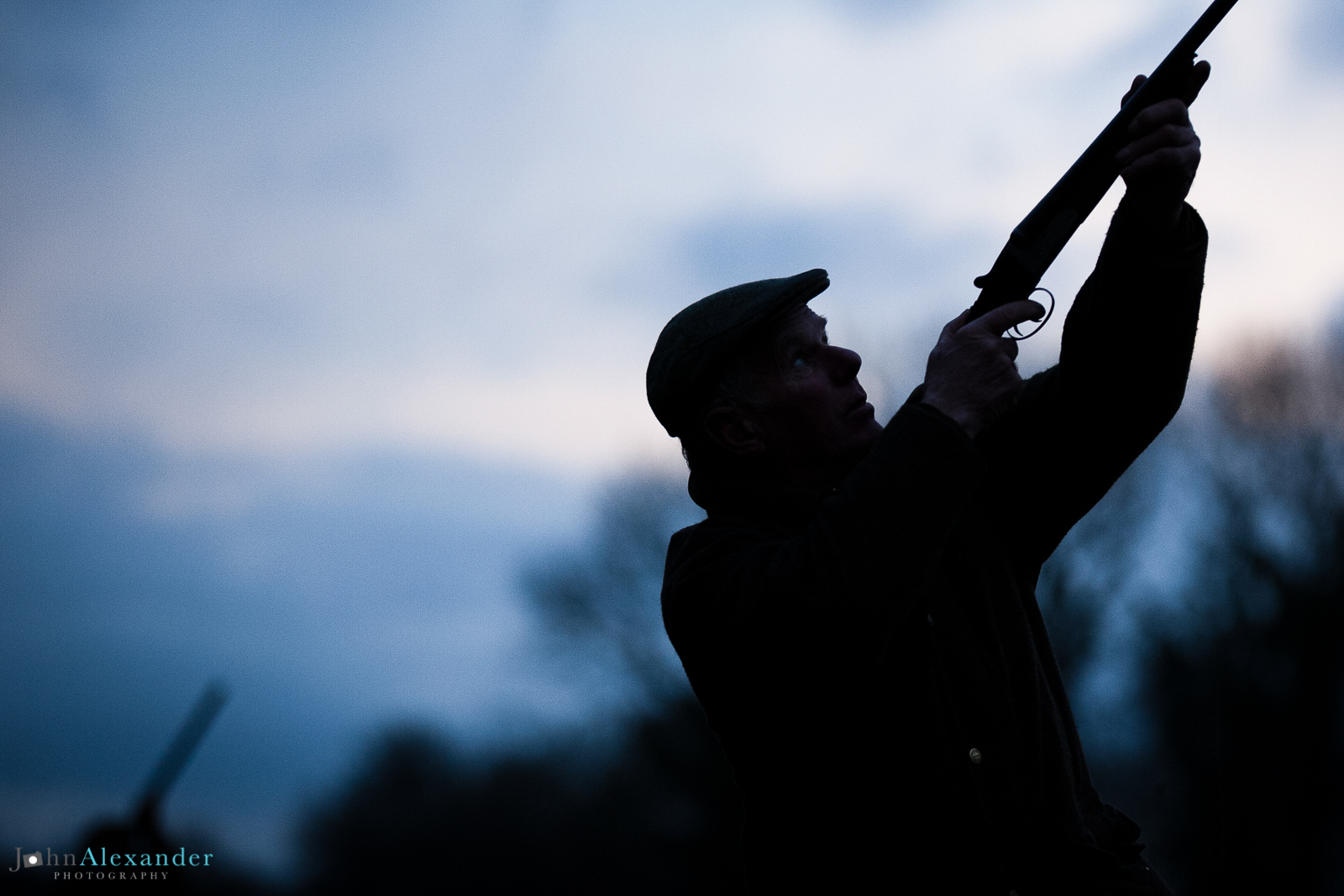 silhouette of gun shooting at dusk