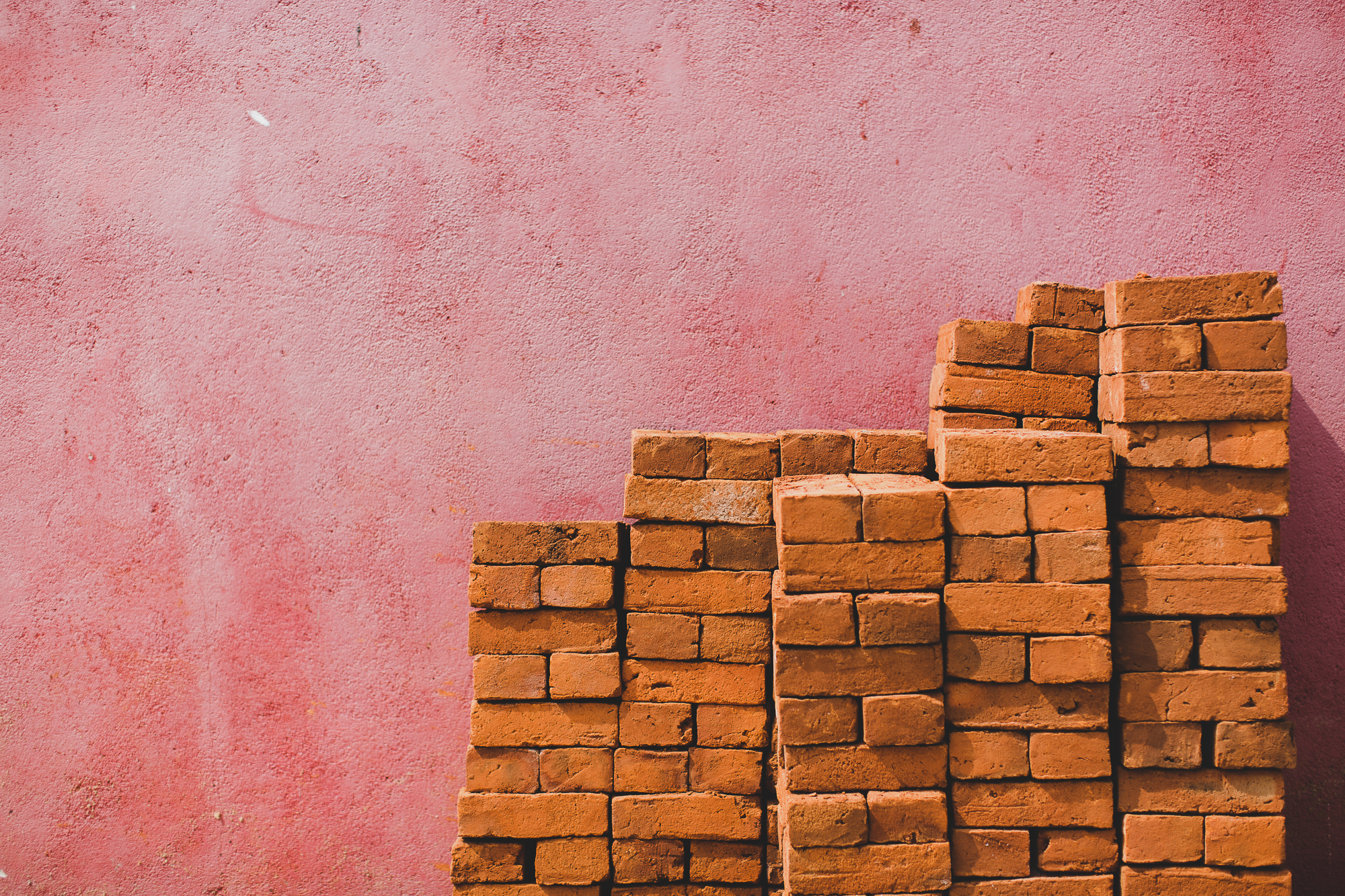 Bricks stacked against a wall