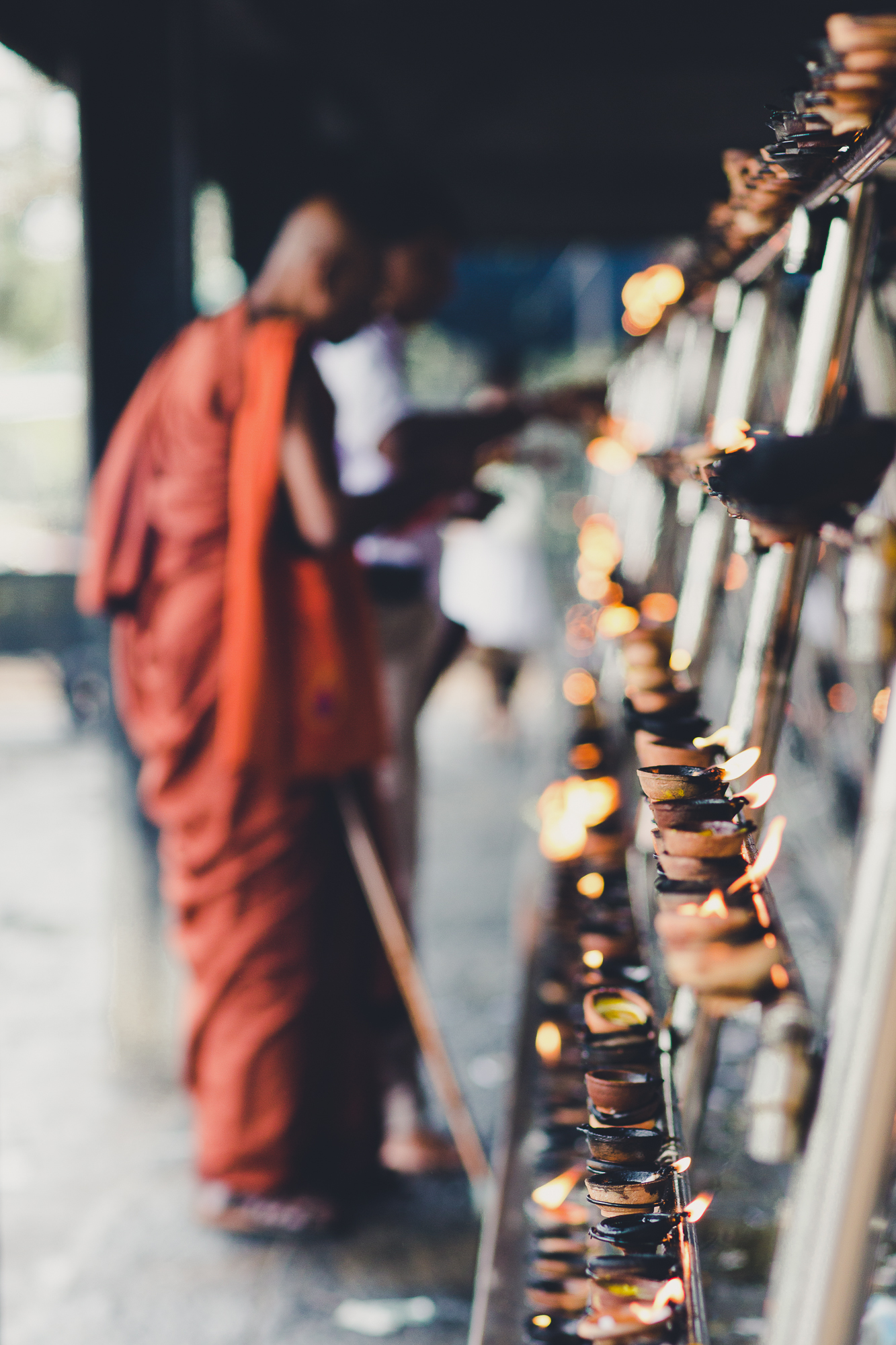 Bhuddist Monk lighting candles